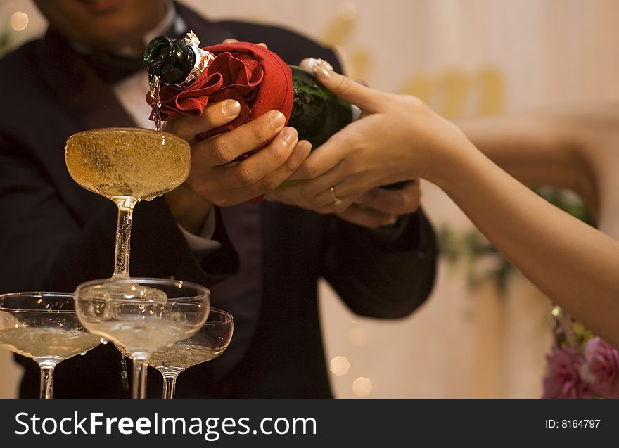 Close up of champagne pouring at wedding dinner reception