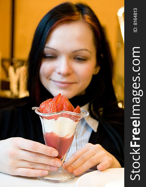 Dessert from a juicy red strawberry in a glass glass
