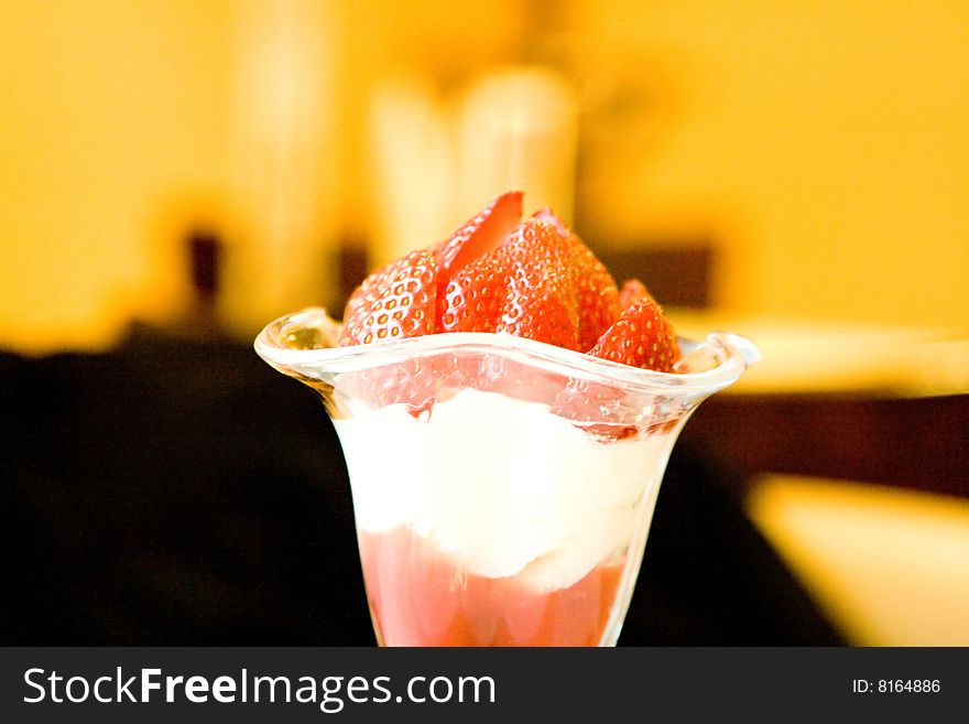 Dessert from a juicy red strawberry in a glass glass