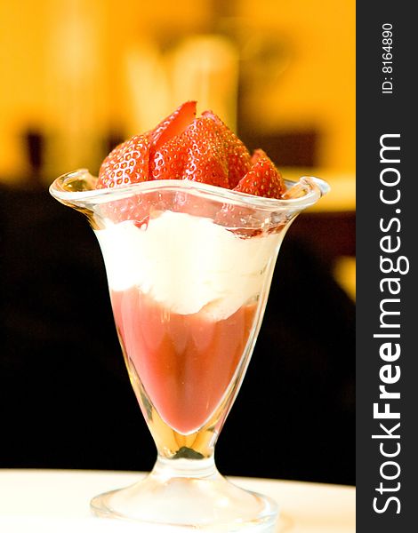 Dessert from a juicy red strawberry in a glass glass