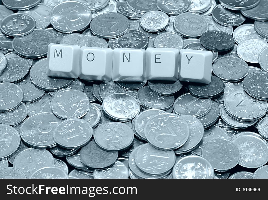 Hi-tech earnings: Money keyboard word over metal coins. Hi-tech earnings: Money keyboard word over metal coins