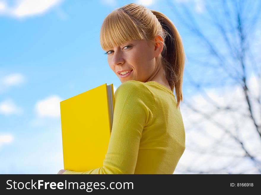 Beautiful Blond Girl With Yelow Book