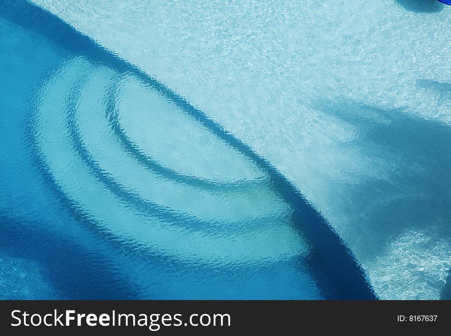 A cool blue pool gets shade from a nearby palm tree in the Gulf of Mexico. A cool blue pool gets shade from a nearby palm tree in the Gulf of Mexico.