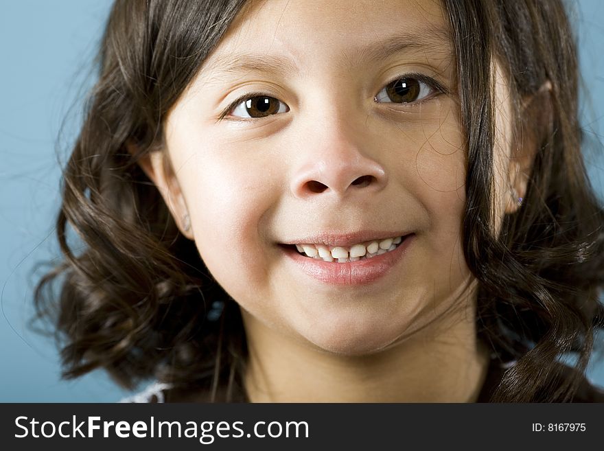 Cute little Hispanic girl smiles for her portrait. Cute little Hispanic girl smiles for her portrait.