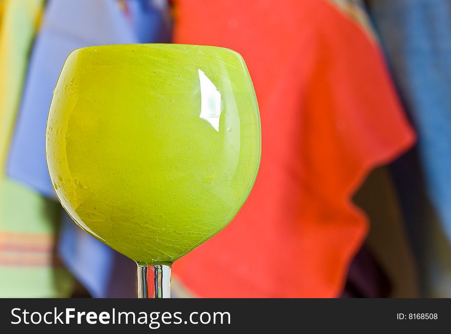 A margarita glass with a brightly colored fabric background. A margarita glass with a brightly colored fabric background.