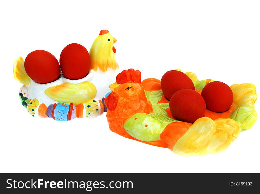 Easter red eggs on the hen and cock on white background.