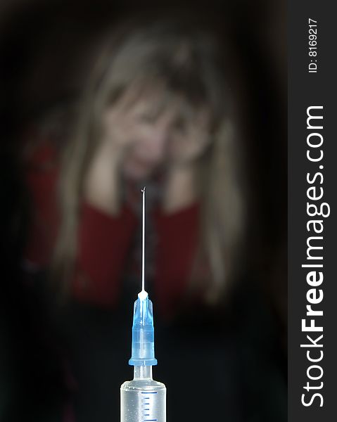 Syringe and outlines of the scared child on a black background. Syringe and outlines of the scared child on a black background