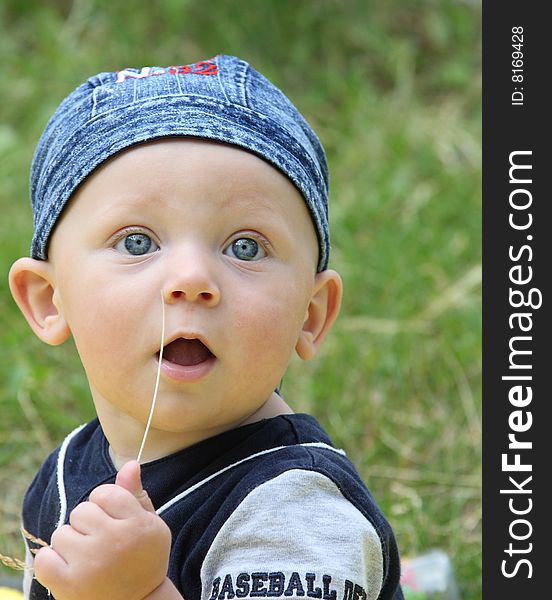 The Little Boy Works As Photomodel On A Meadow