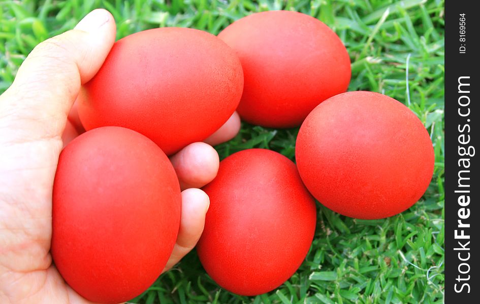 Easter red eggs on the hand.