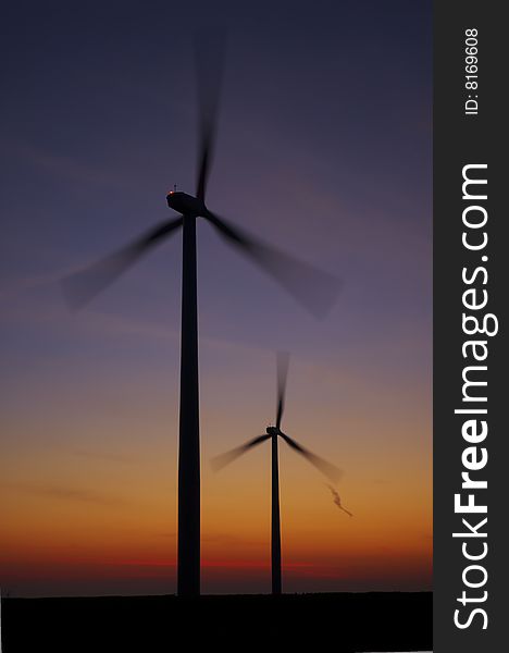 Sunrise and spinning wind turbines