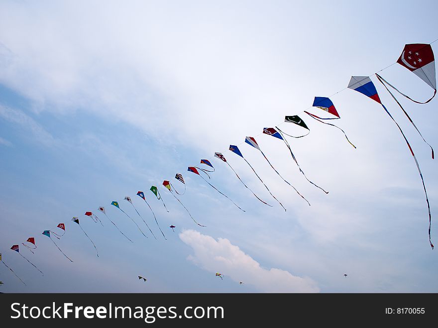 Waving asian countries national flag kites in action