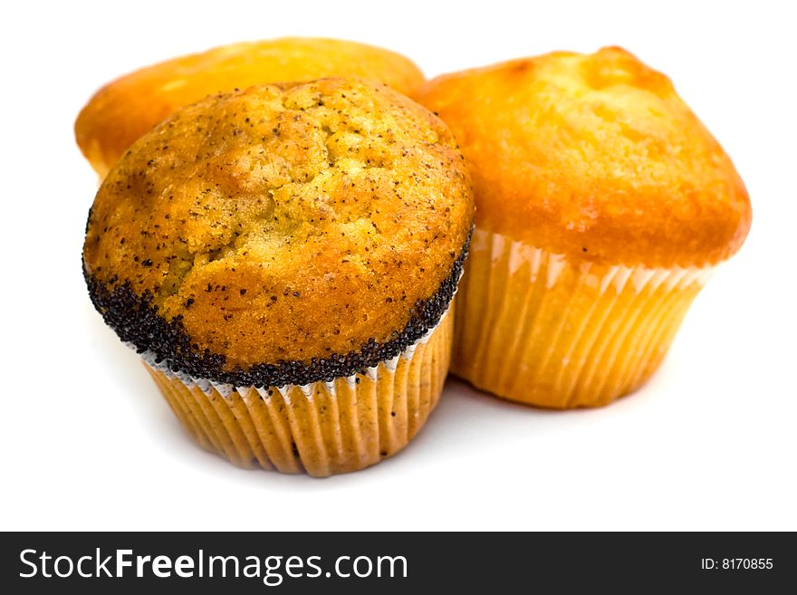 Three tasty muffins with poppies isolated on white background. Three tasty muffins with poppies isolated on white background