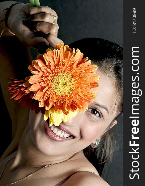 Girl model holding a orange flower. Girl model holding a orange flower.