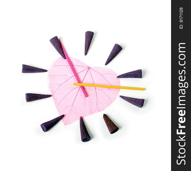 Clock by aroma sticks isolated over white