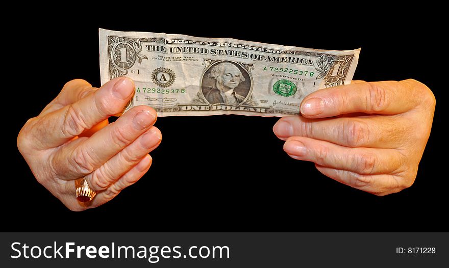 A elderly hand holds a money note. A elderly hand holds a money note