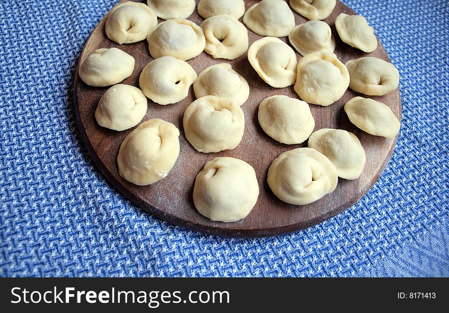 Pel'menis or raviolli with meat - a dish characteristic for the Italian, Russian, Ukrainian and Chinese kitchen. In this picture - the home  made Russian pel'menis.