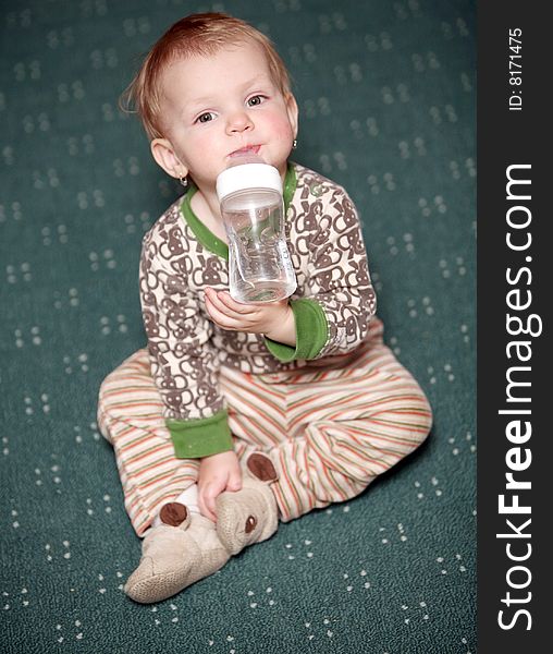 Small baby girl drink watter from a bottle