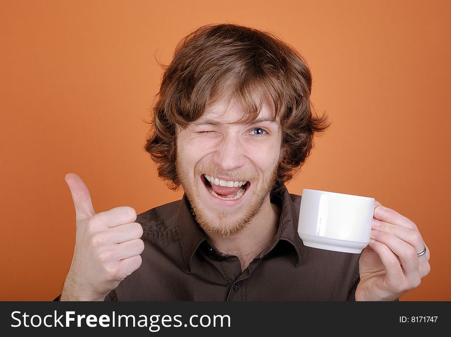 The emotional man with a cup in a hand and with copy space. The emotional man with a cup in a hand and with copy space