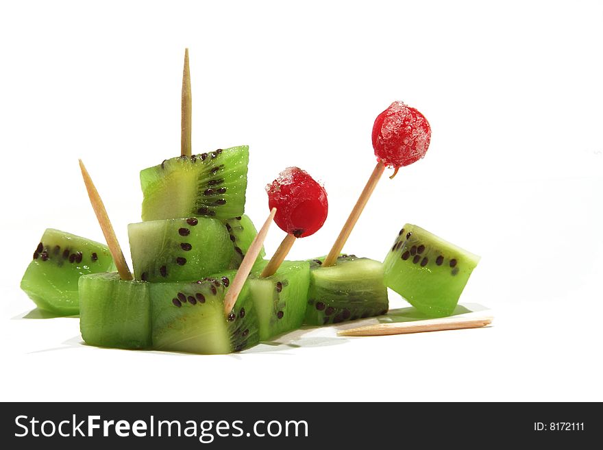 Kiwi cubes with toothpicks and redcurrants. Kiwi cubes with toothpicks and redcurrants.