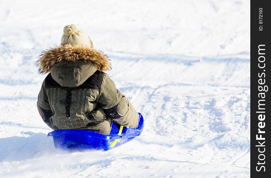 Child on a sled - winter holiday