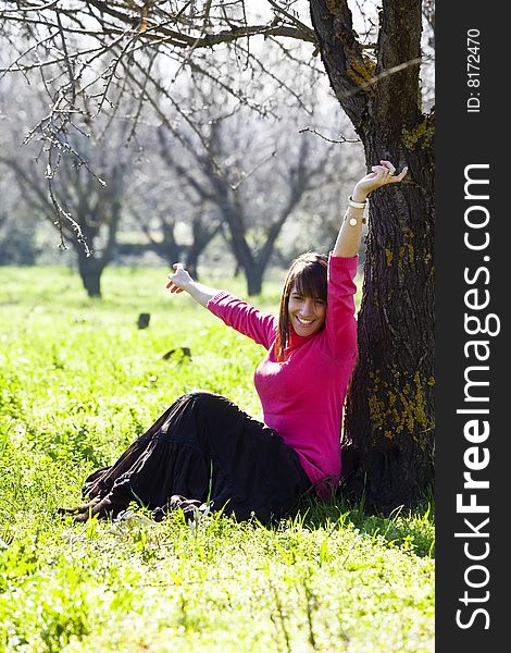 Young cheerful woman in a green forest. Young cheerful woman in a green forest.