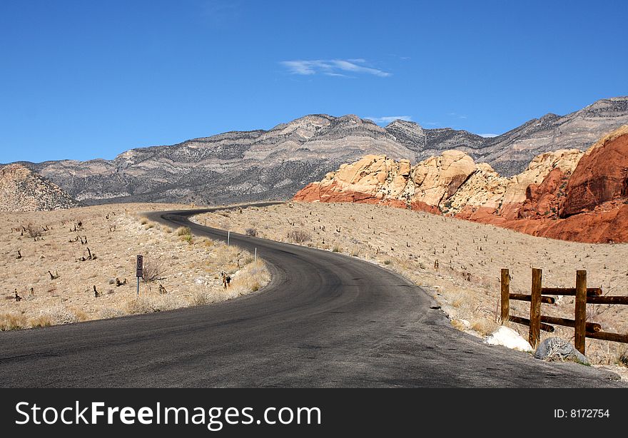 A Blacktop Highway Winding Through the Colorful Desert. A Blacktop Highway Winding Through the Colorful Desert