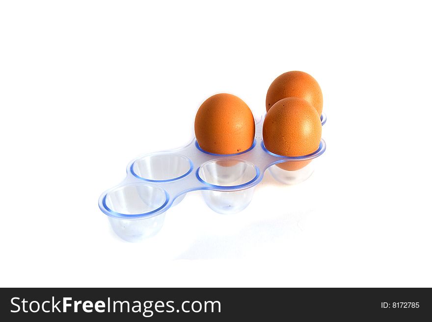 Eggs int the eggbox close up, isolated over white