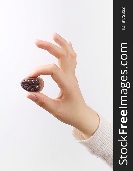 Hand holding chocolate isolated on white background
