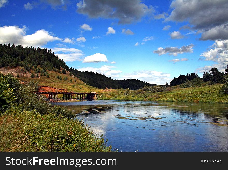 Beautiful Iren` river with wooden bridge near Kungur city, Ural region