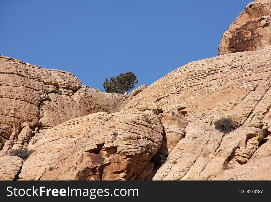 Brown and red desert landscape under a vivid blue sky