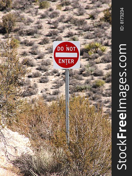 Do Not Enter sign surrounded by desert brush