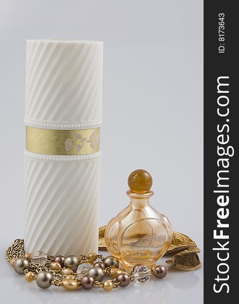 Arrangement with two perfume bottles and necklace