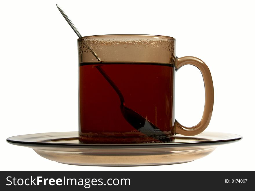 Glass cup of tea with spoon isolated on white