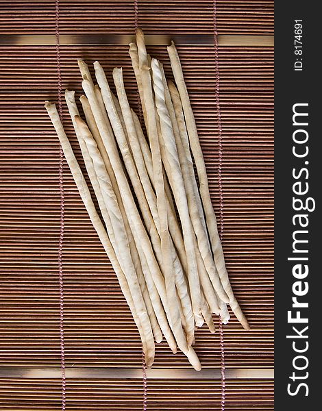Bread sticks on a bamboo pad