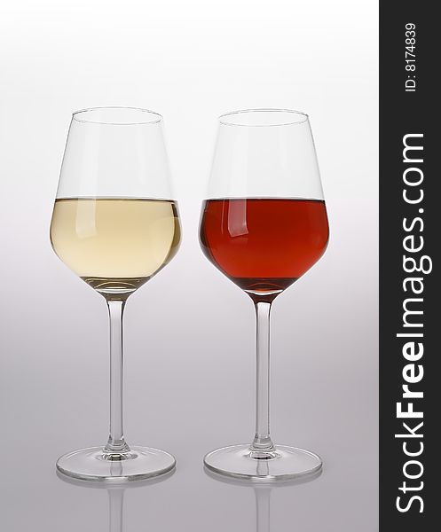 Glasses of red and white wine with reflection. Glasses of red and white wine with reflection