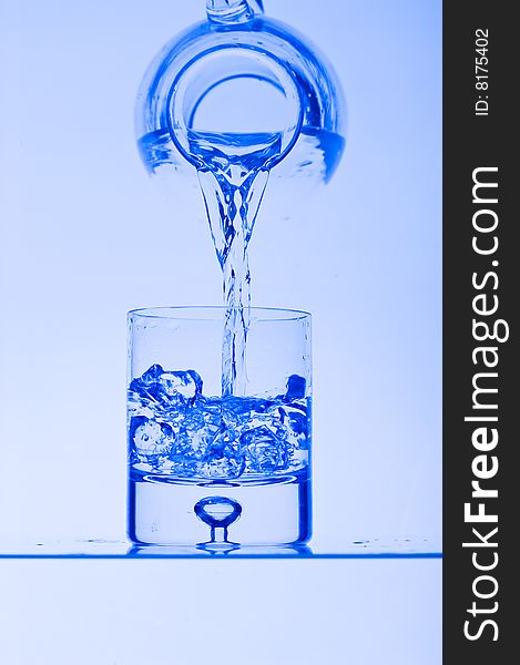Blue Glass with Splashing water. Coolness Drink. Blue Glass with Splashing water. Coolness Drink