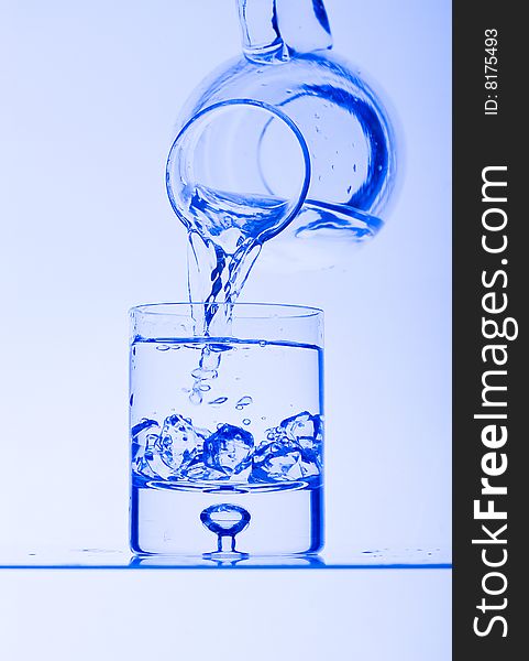 Blue Glass with Splashing water. Coolness Drink. Blue Glass with Splashing water. Coolness Drink