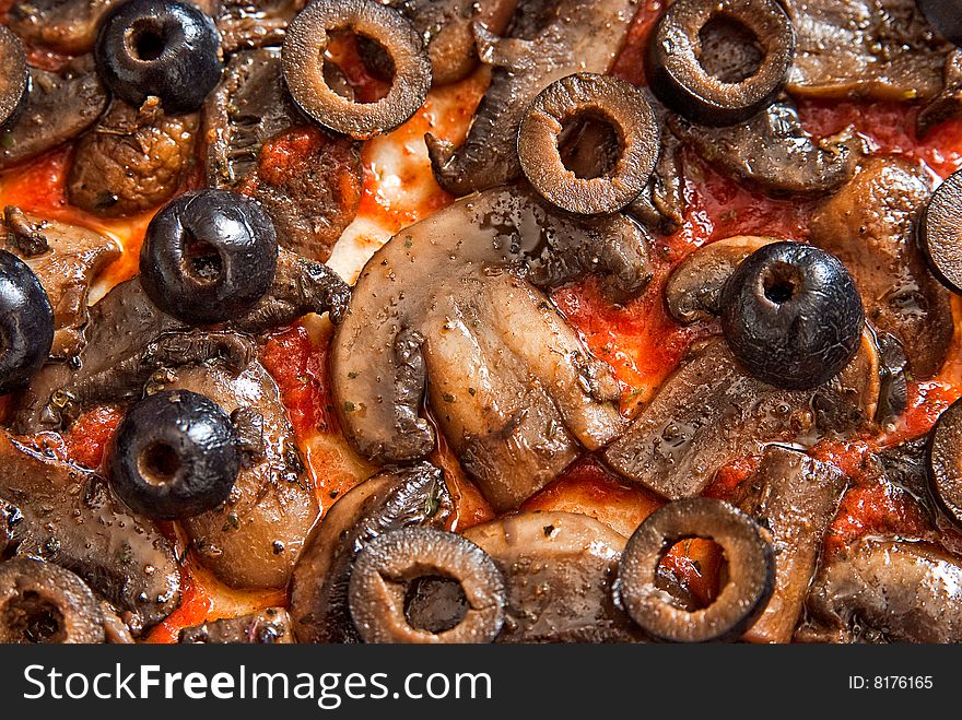 Closeup Photo of a Pizza with mushrooms and tomato sauce. Closeup Photo of a Pizza with mushrooms and tomato sauce