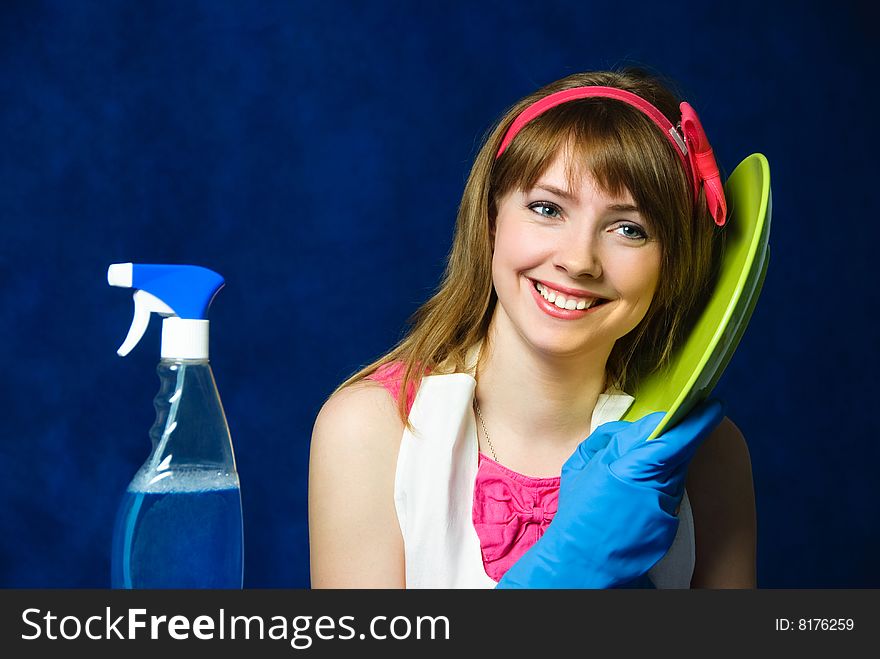 Portrait of a beautiful cheerful young housewife washing the dishes