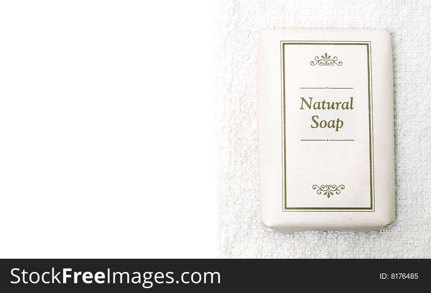 Bar of natural soap on white towel