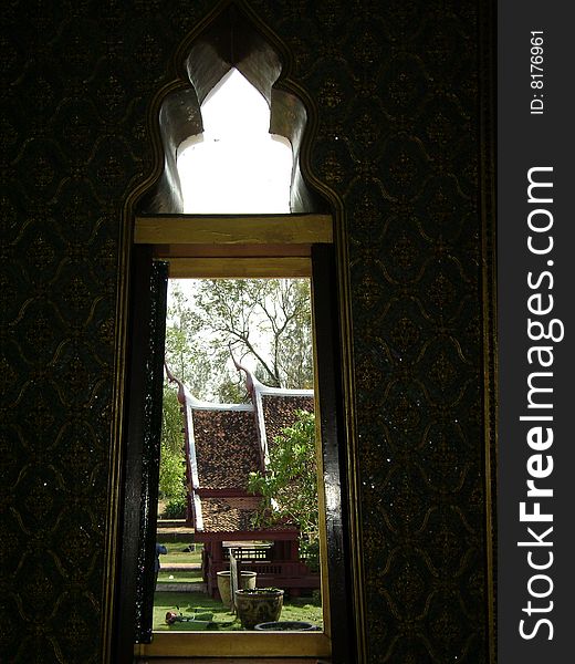 Remote view through a long vertical window of traditional Thai pavilion. Remote view through a long vertical window of traditional Thai pavilion