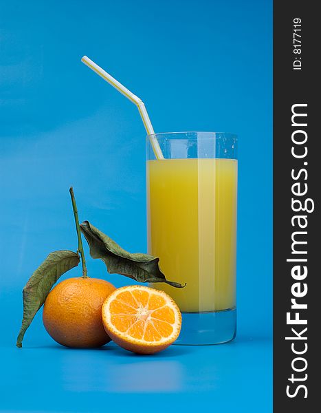 Tangerines and juice on a dark blue background