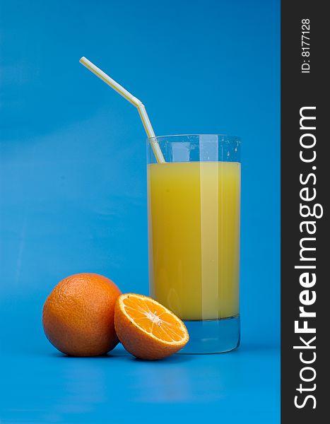 Tangerines and juice on a dark blue background