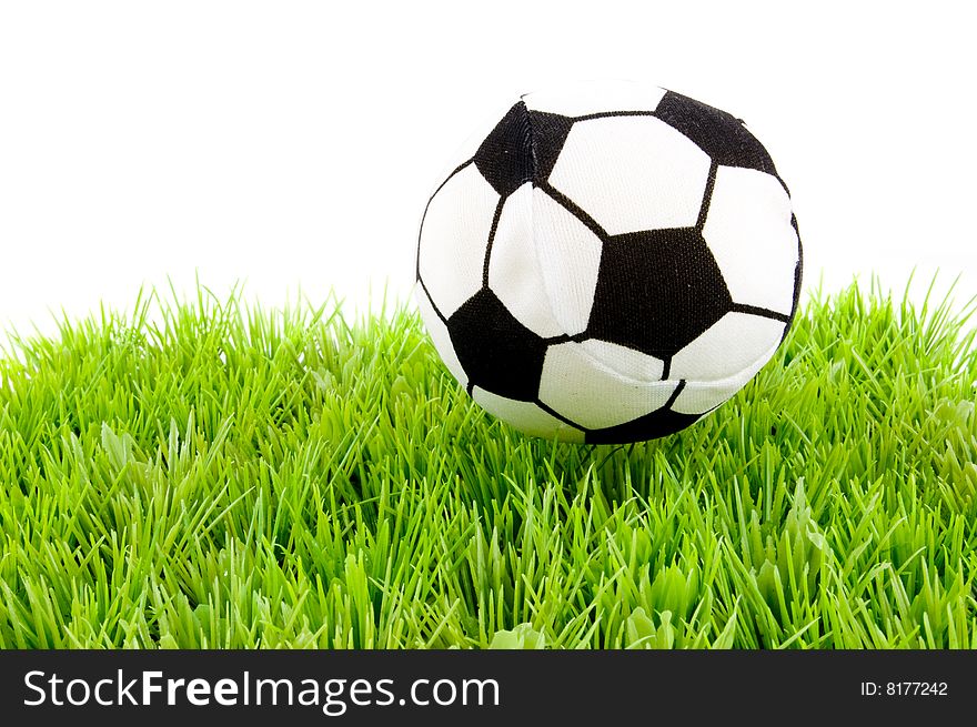 Soccerball on the grass isolated on white