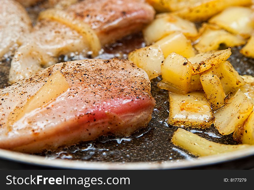 Pangasius filet frying with yellow peppers. Pangasius filet frying with yellow peppers