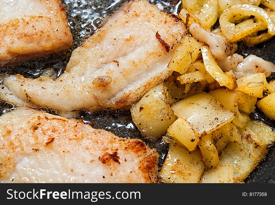 Pangasius filet frying with yellow peppers. Pangasius filet frying with yellow peppers