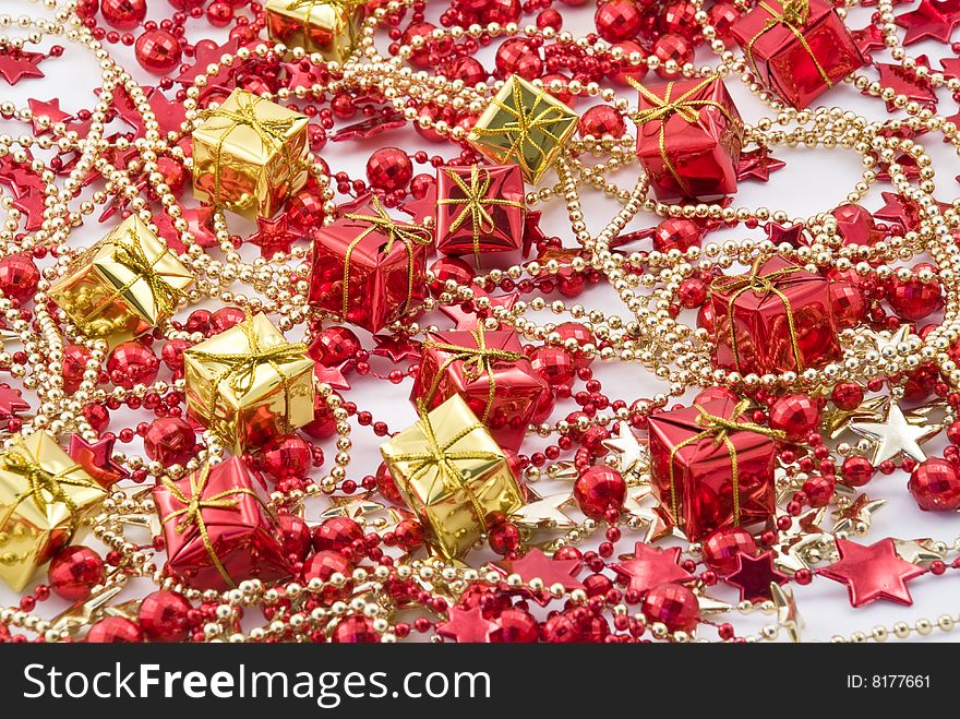 Beautiful holiday background with golden and red boxes and beads