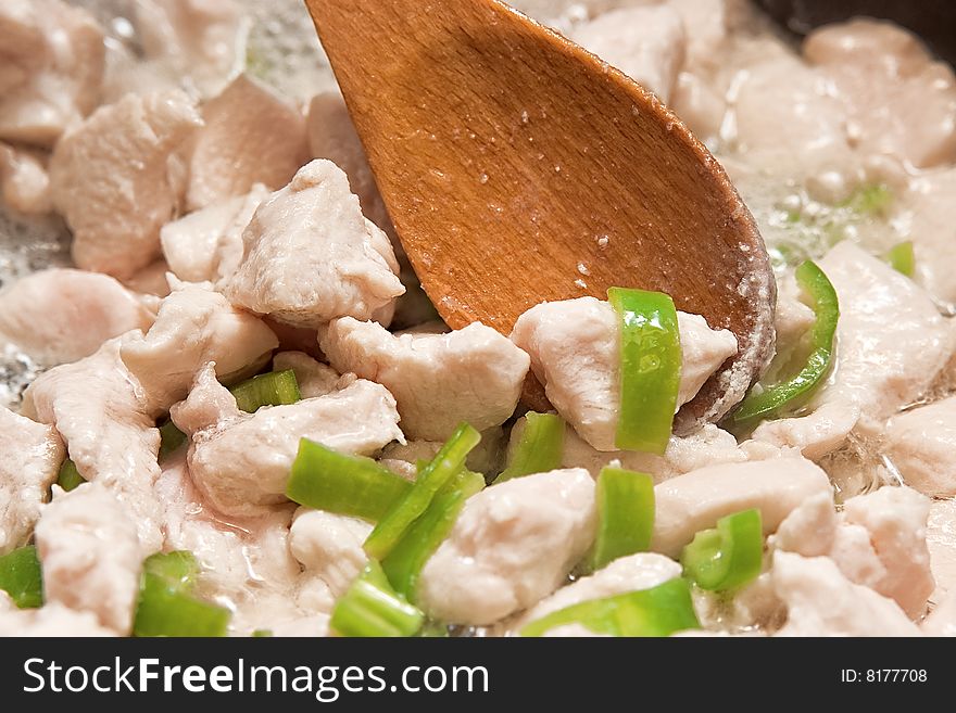 Cooking chicken breast with green peppers