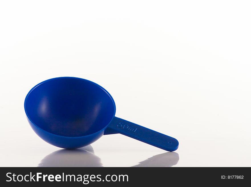 Image of a blue plastic measuring spoon showing a 50ml capacity. Image of a blue plastic measuring spoon showing a 50ml capacity