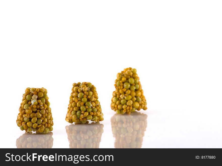 Three plant food pellets in a line
